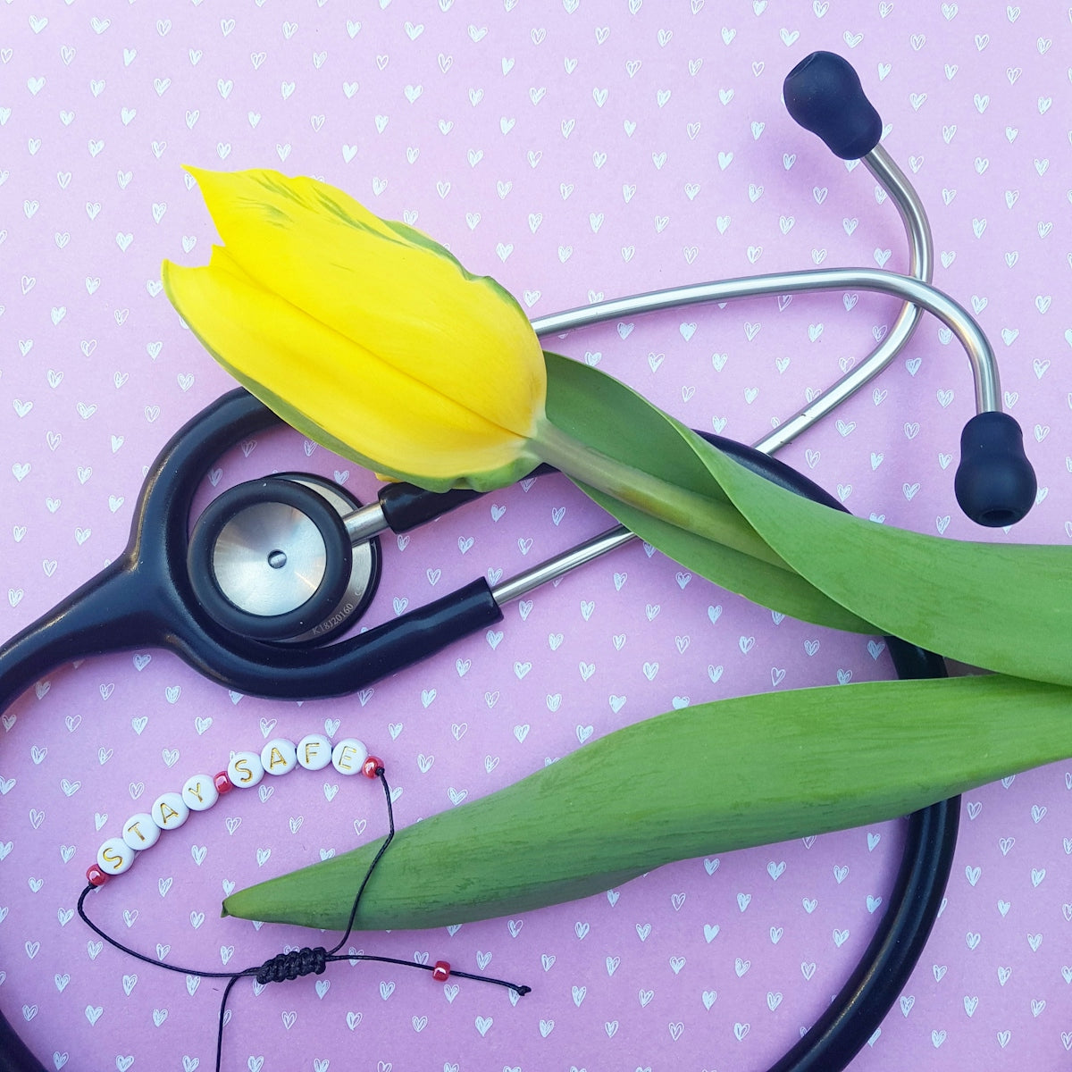 black and silver stethoscope on yellow textile