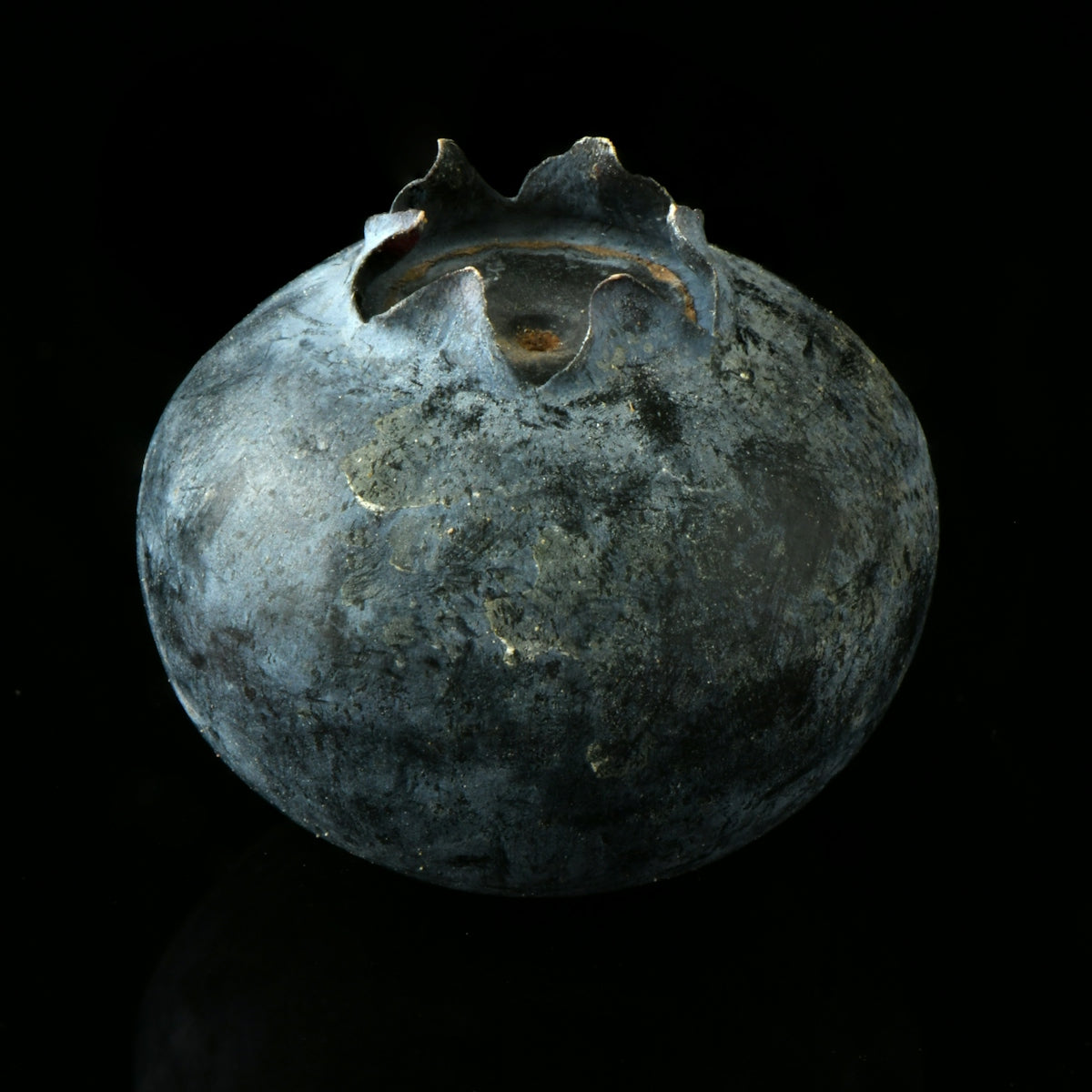 a blue vase sitting on top of a black table